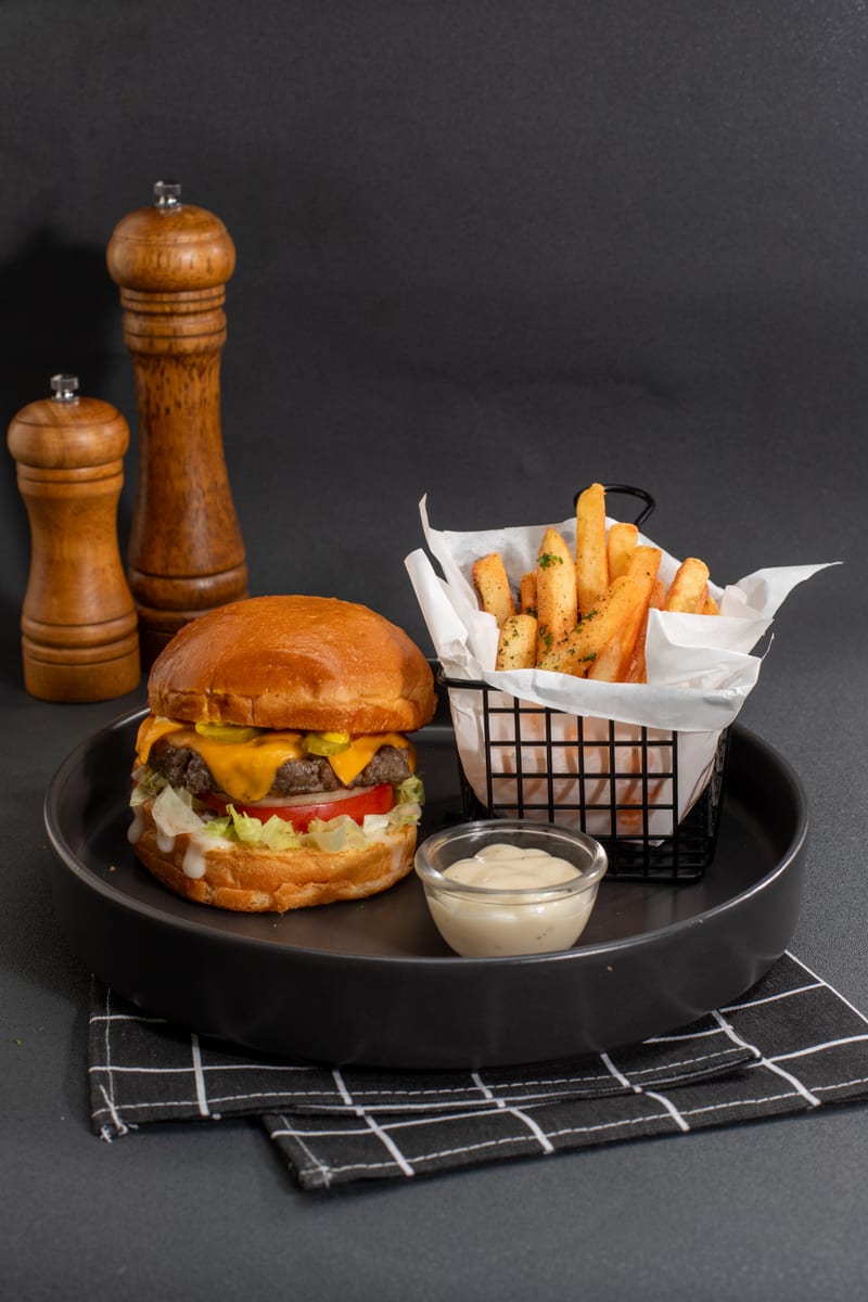 Cheeseburger with a basket of fries