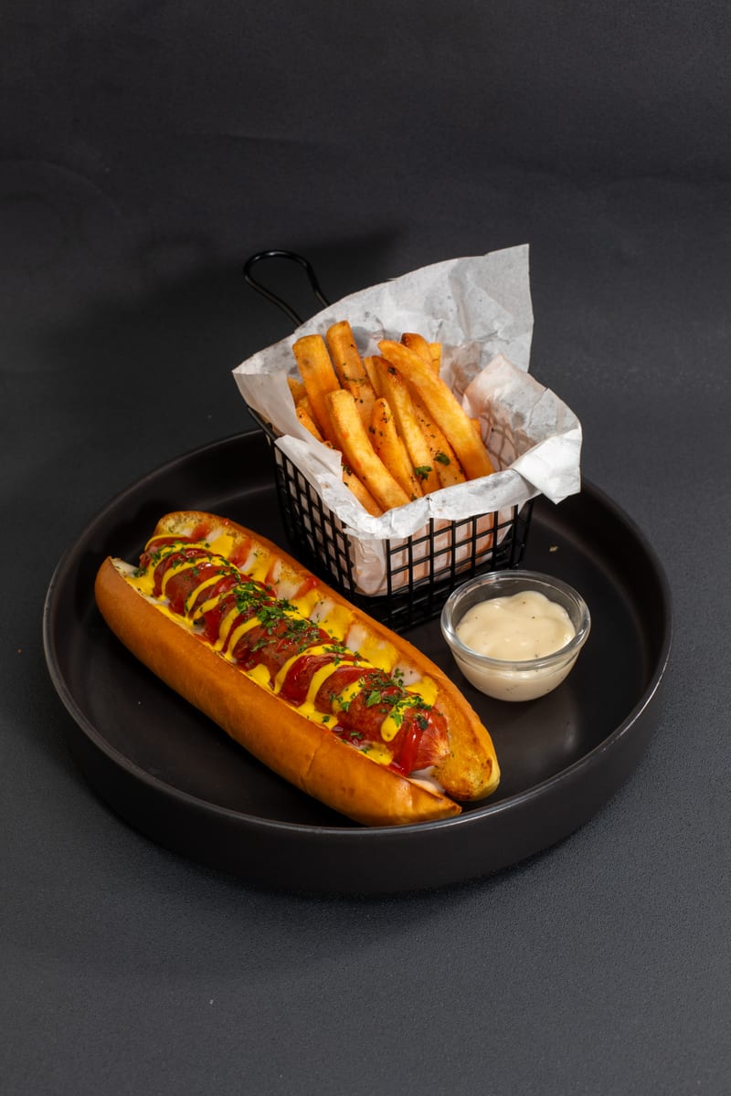 Hot dog with mustard and pickled chilli, served with fries