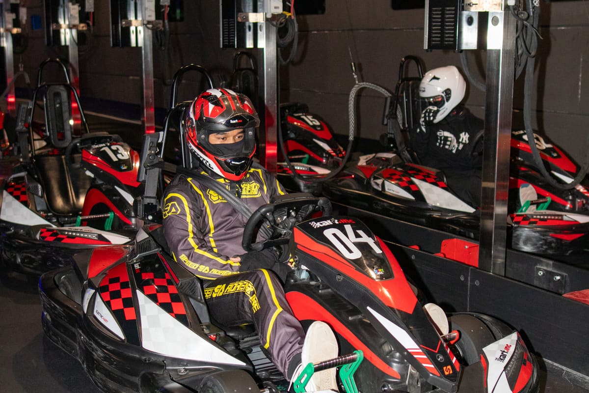 Helmeted drivers on the grid before a night round