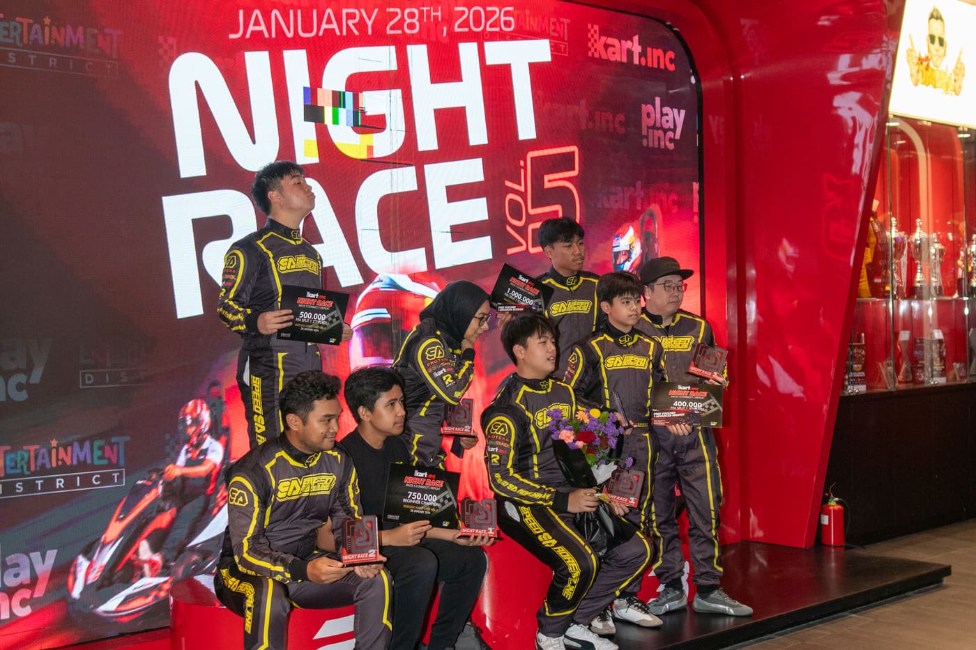 Drivers celebrating on the KPL podium with trophies